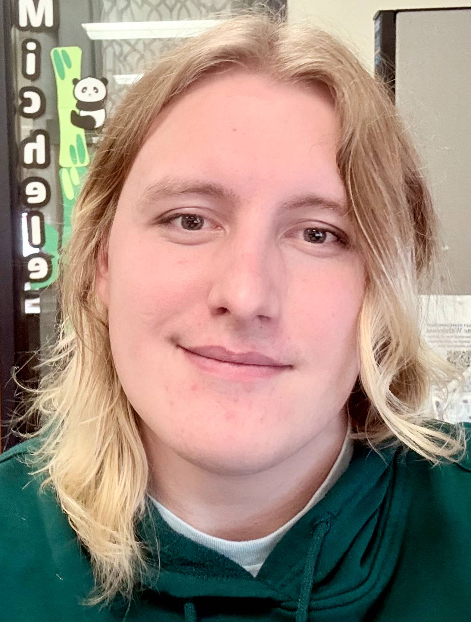 Wyatt Purucker outside, leaning against a rustic building